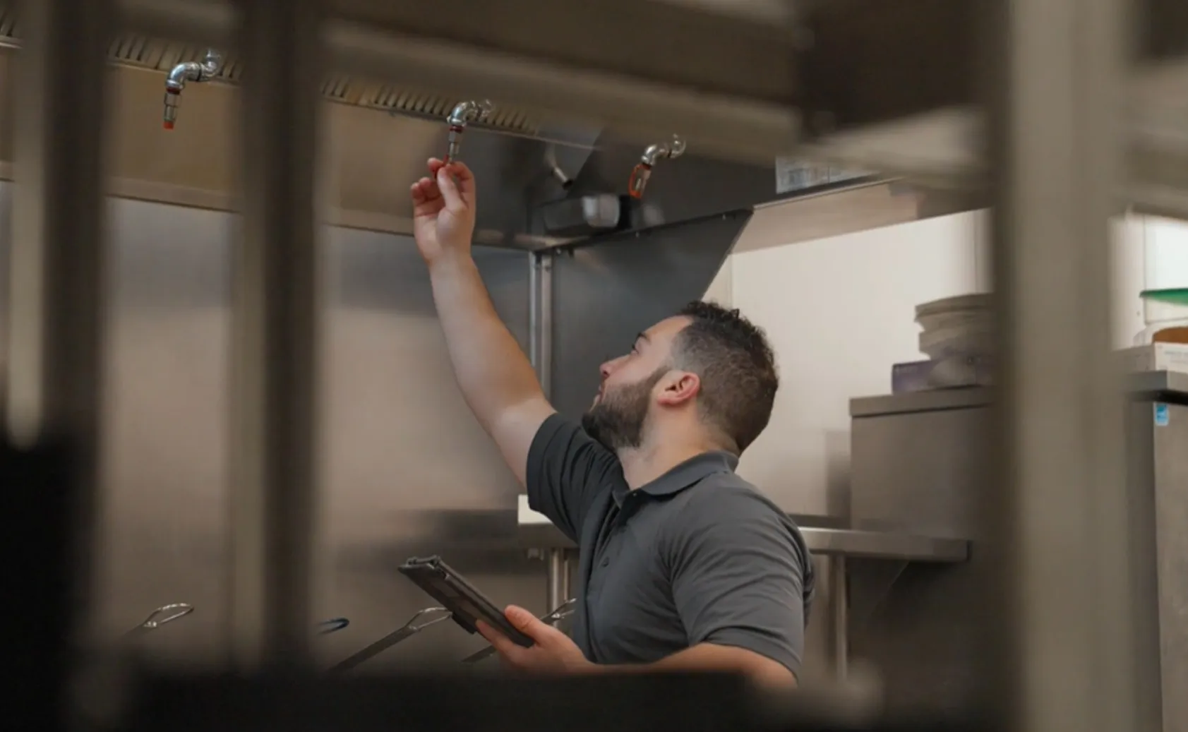 Technician servicing kitchen equipment